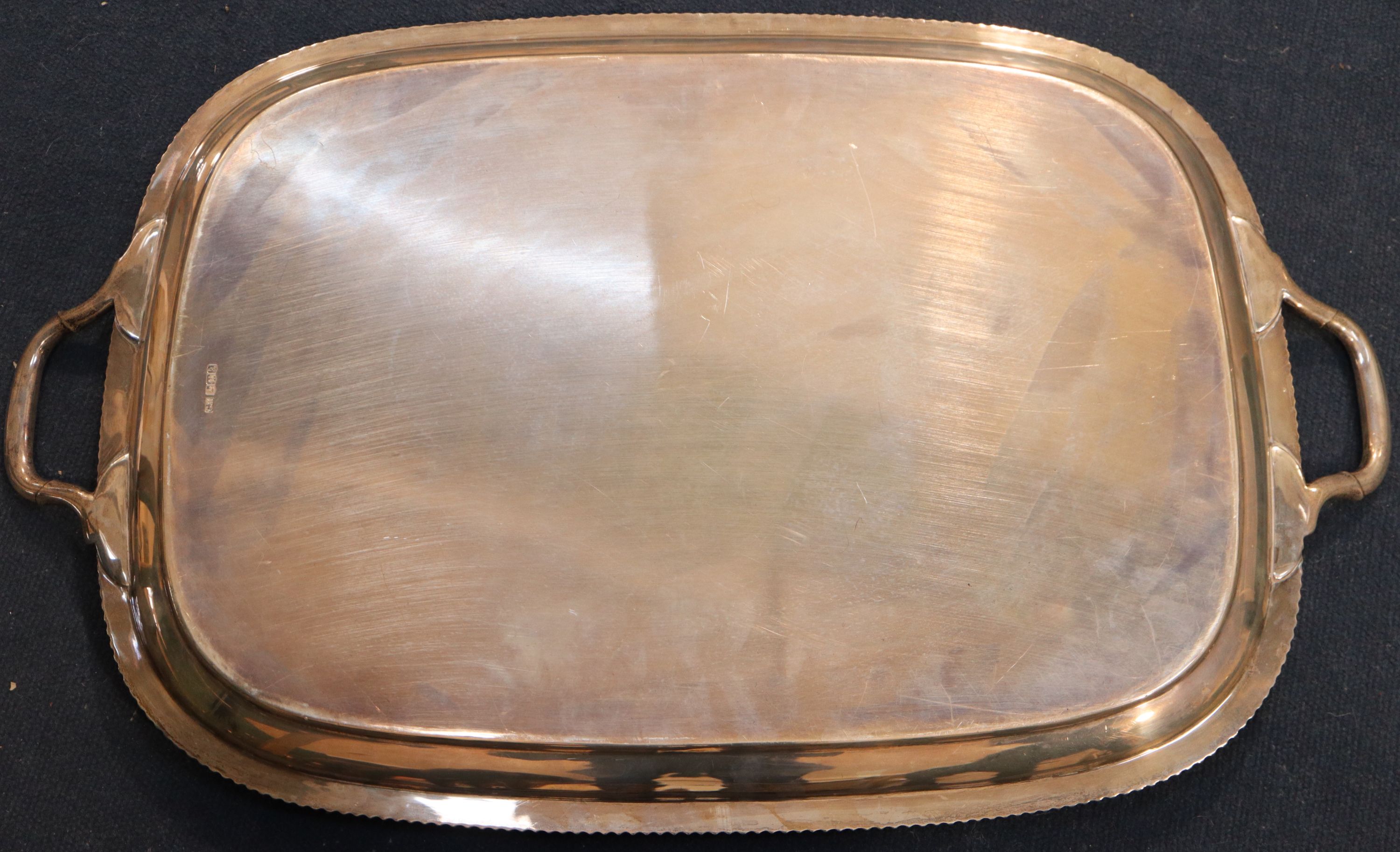 A George V silver two handled tea tray, 64.7cm over handles, 98oz.